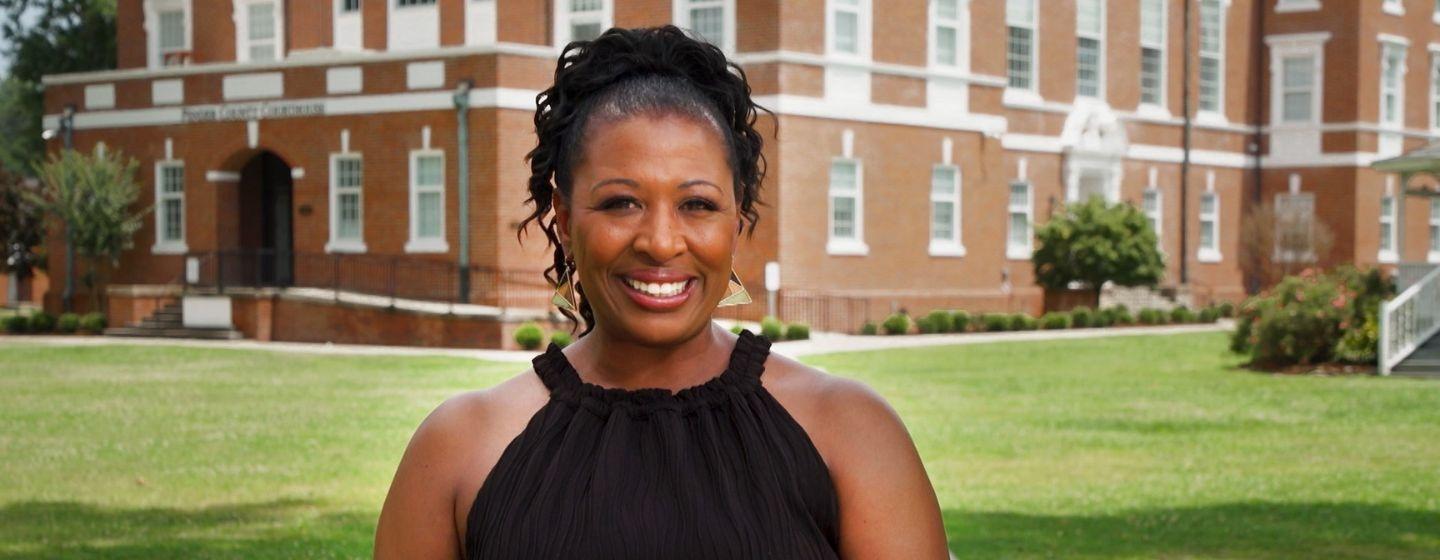 Deborah Holt Noel smiles for the camera in her simple black tank top.