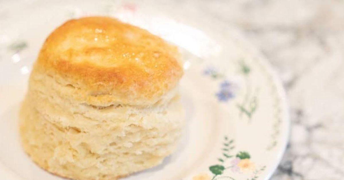Close up of a biscuit on a flowery tea plate.