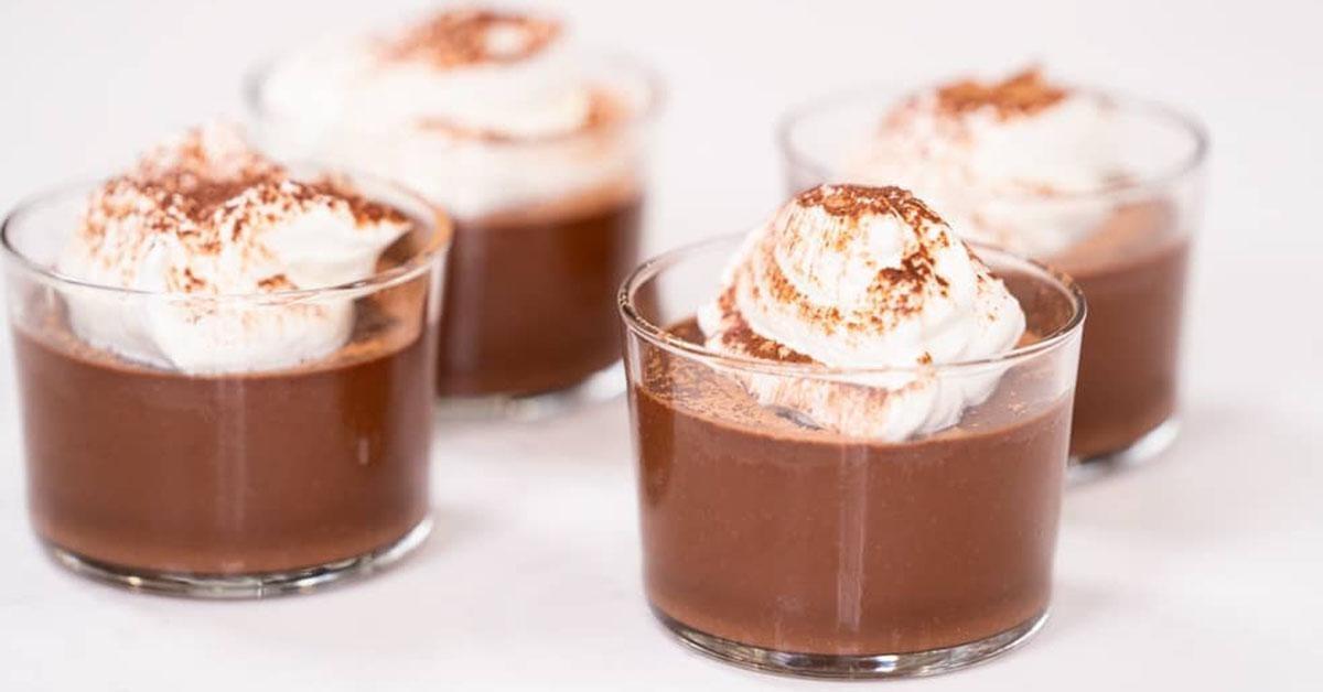 4 Buttermilk pudding cups with cream on top.