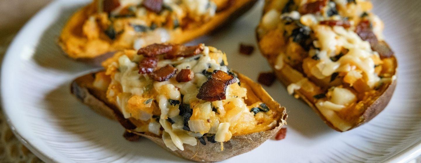 Twice-baked sweet potatoes on a white ceramic plate.