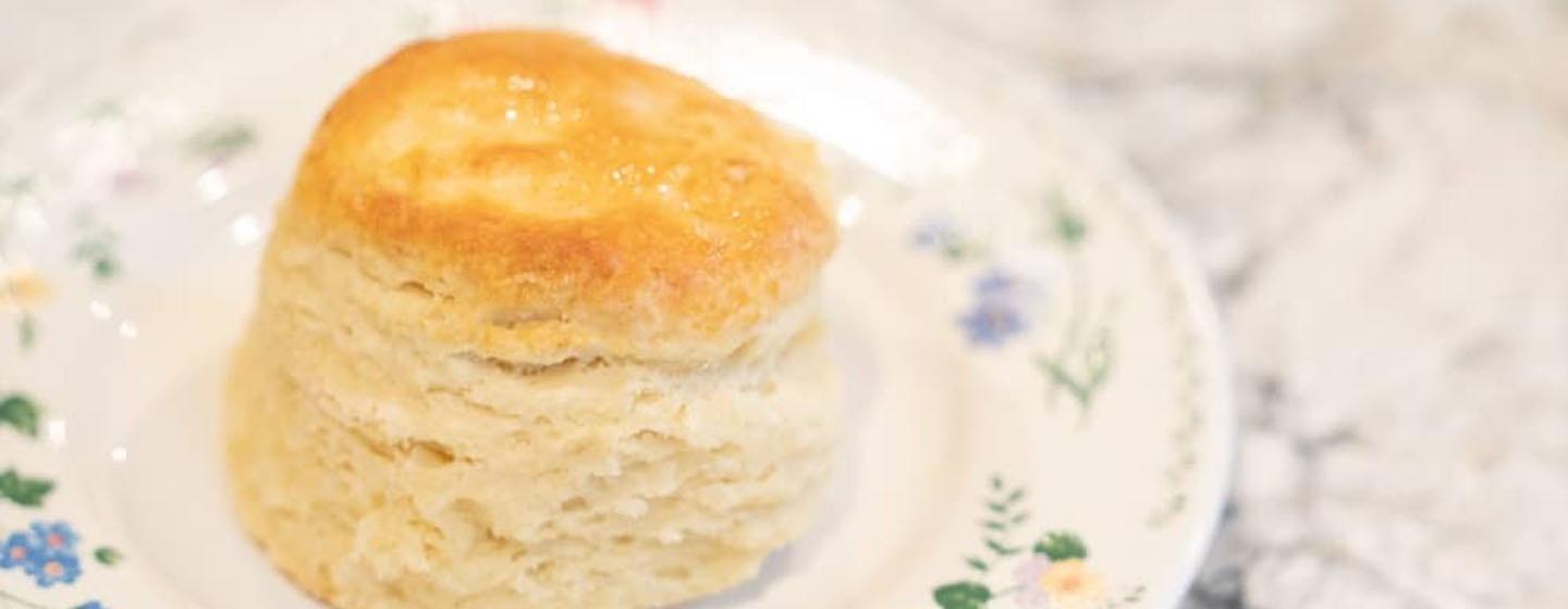 closeup of buttermilk biscuit sitting on a plate