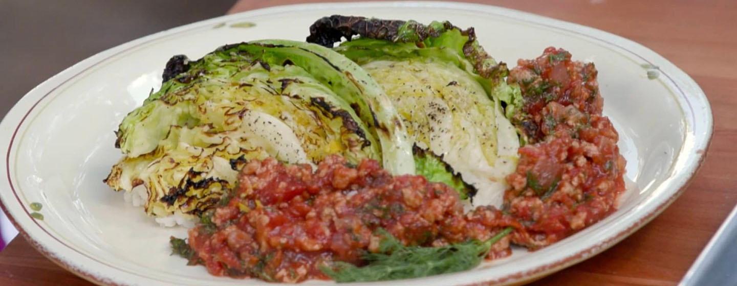 Grilled cabbage wedges with sweet & sour meat sauce on plate
