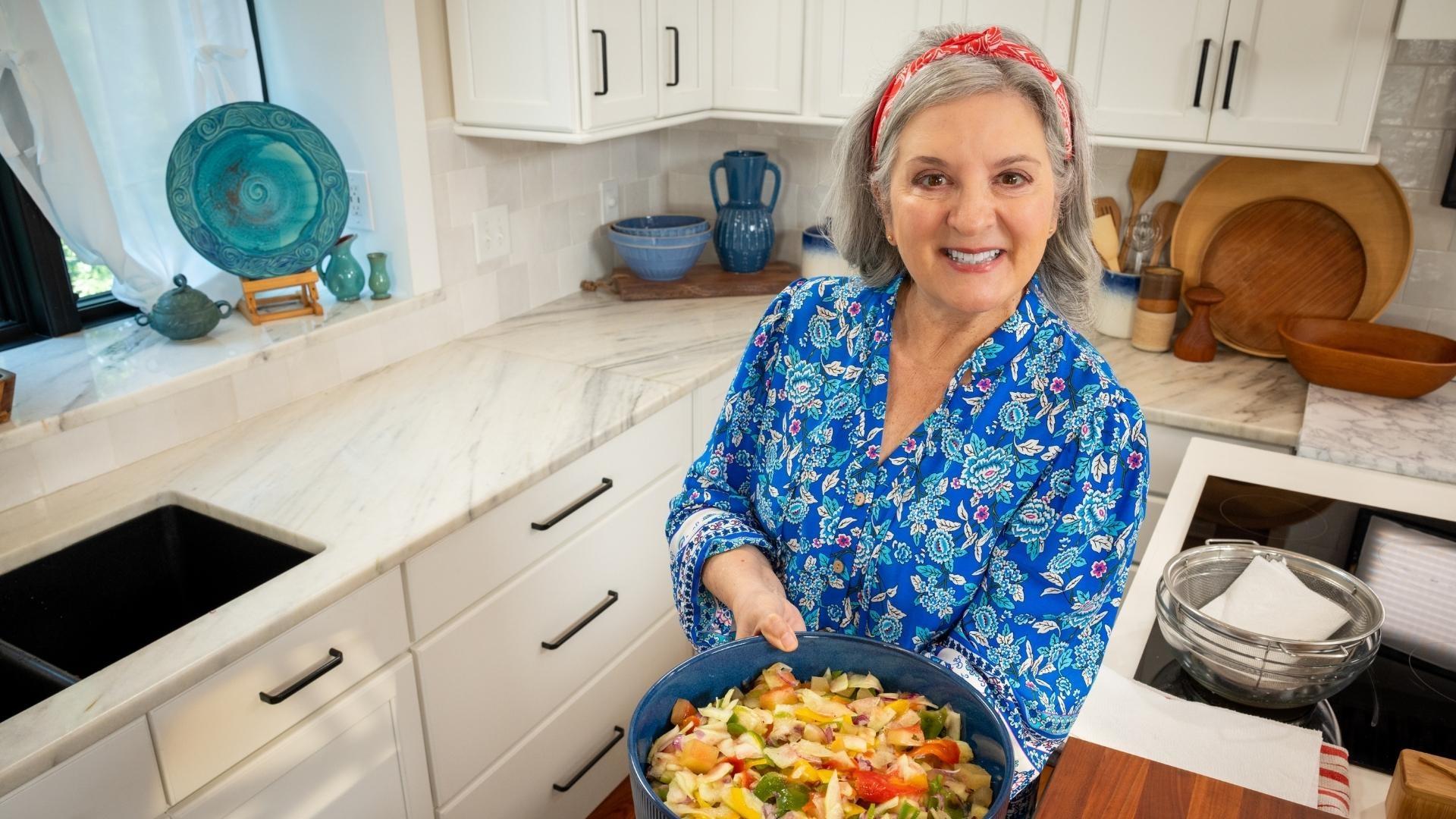 Sheri Castle holding up a plate of watermelon slaw.