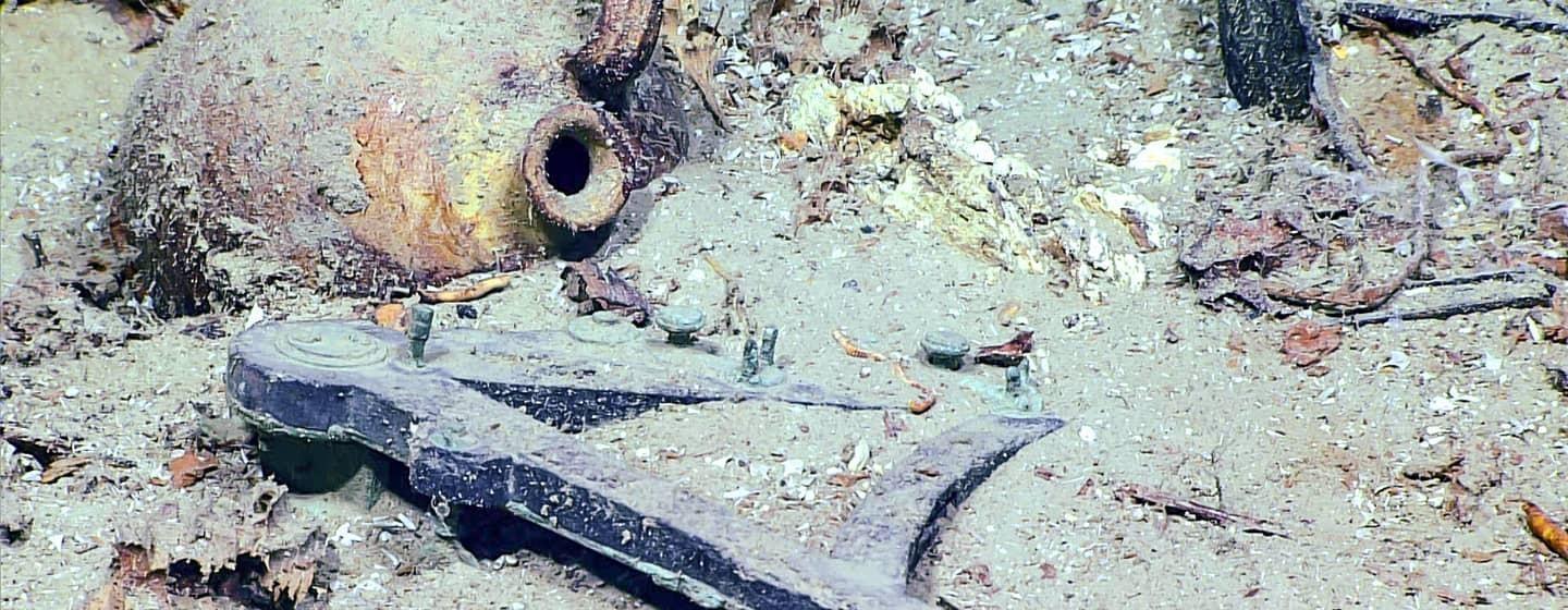 underwater footage of shipwreck and anchor submerged in ocean floor sand take by noaa ocean explorer