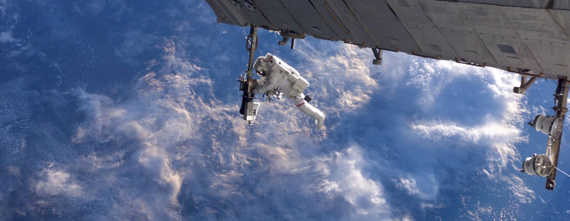 astronaut taking picture from space shuttle station over foggy planet earth atmosphere