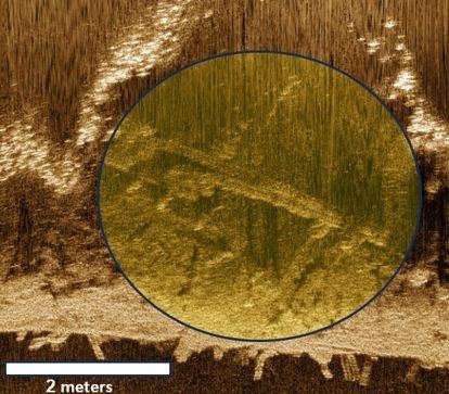 A yellow circle highlights findings in this side-scan sonar image.