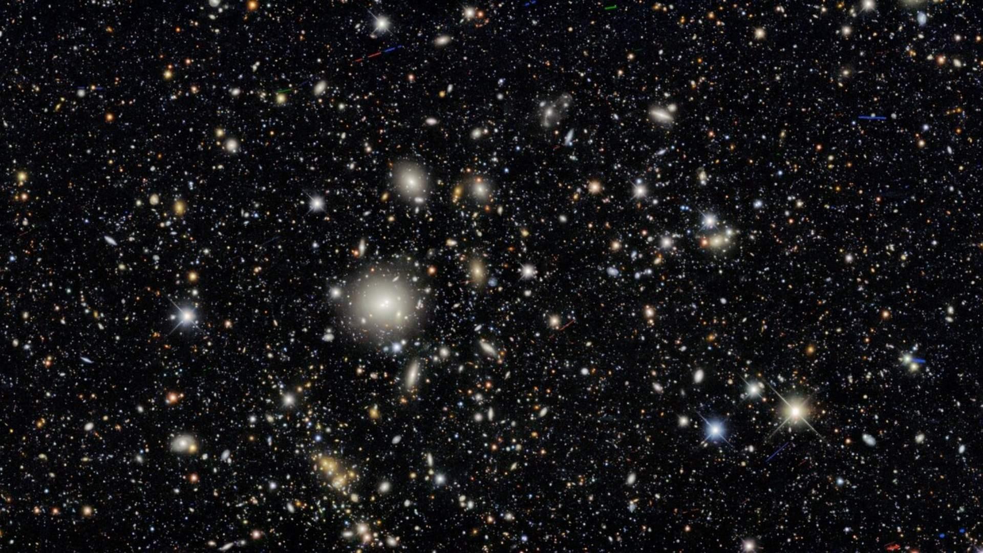 The image is teeming with galaxies — in fact, nearly every single object in this image is a galaxy. Some exceptions include a couple of dozen asteroids as well as a few handfuls of foreground stars in our own Milky Way.