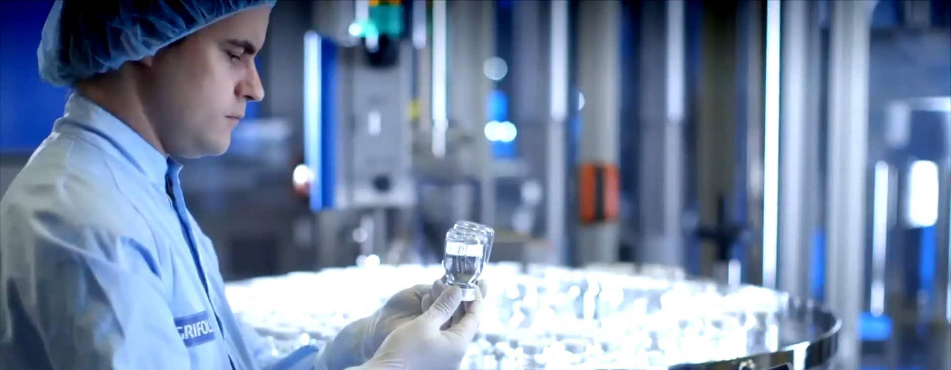 A scientist holds up vials