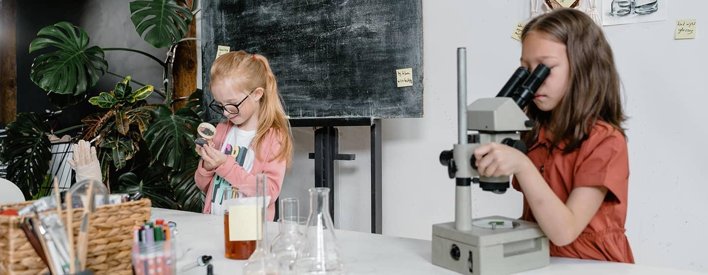 Two children at play with general science lab equipment