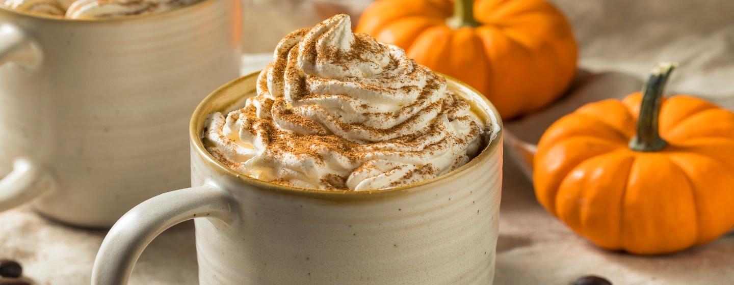pumpkin spice latte in mug with whipped cream top and cinnamon on top, fall aesthetic