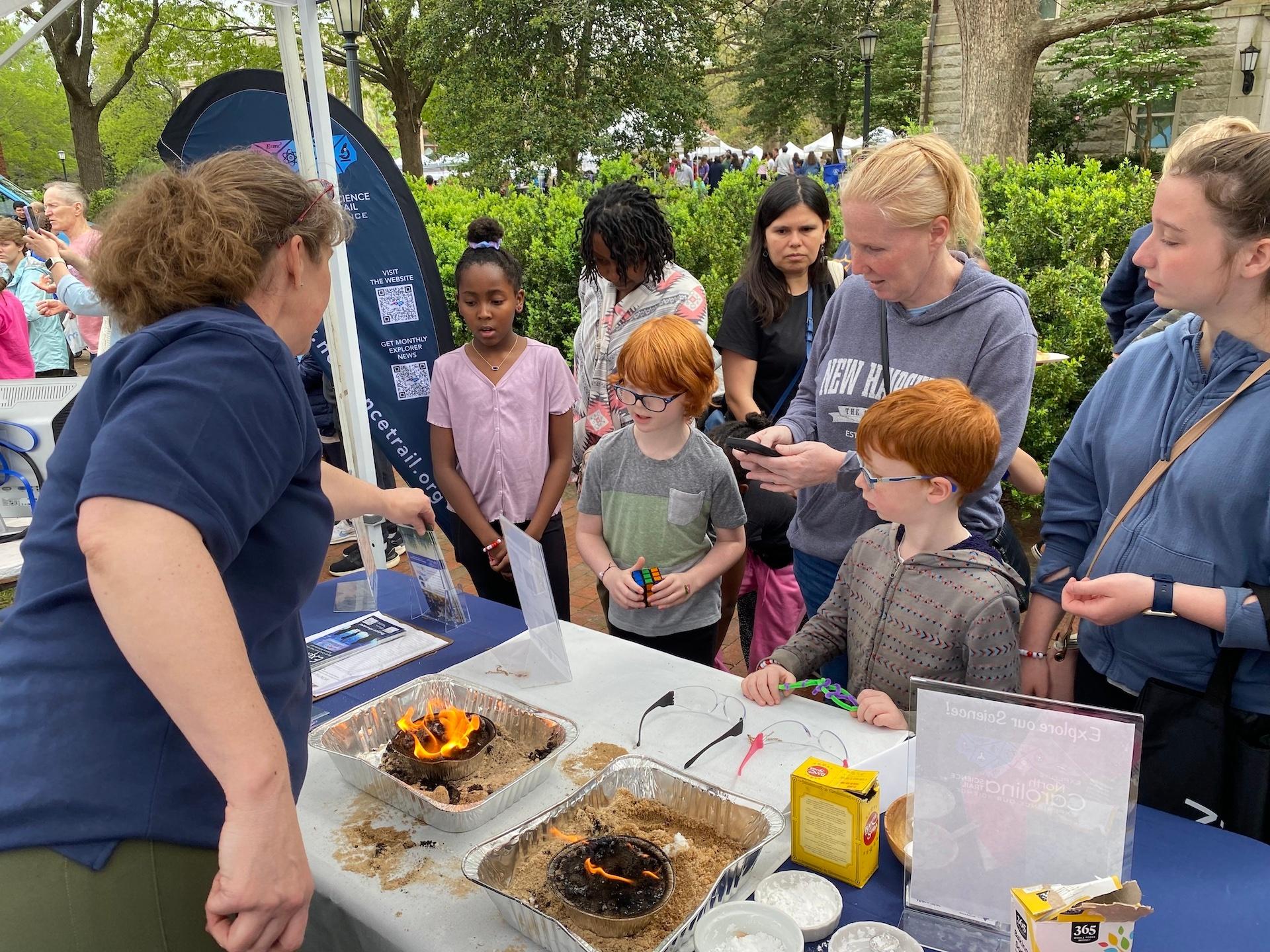 Children and adults at the NC Science Trail booth at the UNC Science Expo