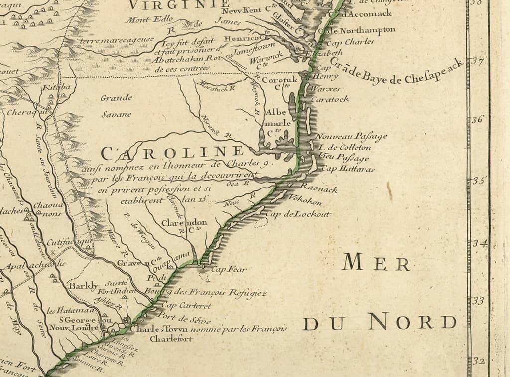 A portion of a map yellowed with age with the French word Caroline in the middle and drawings of mountain ranges, rivers and coastlines.