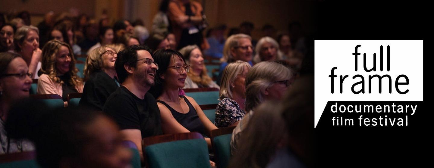 People sitting in a theatre (image courtesy of Kaylin Tsukayama, from the 2025 Full Frame Festival) with the Full Frame Documentary Film Festival logo to the right.