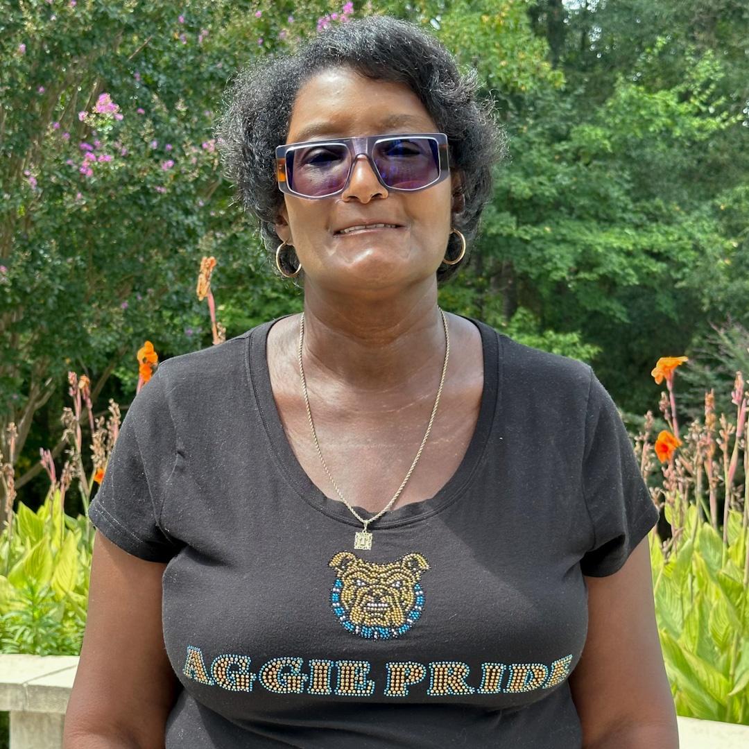 Tyran Fennell wearing a black tee shirt with "AGGIE PRIDE" and the North Carolina A&T mascot in gold and teal rhinestones.