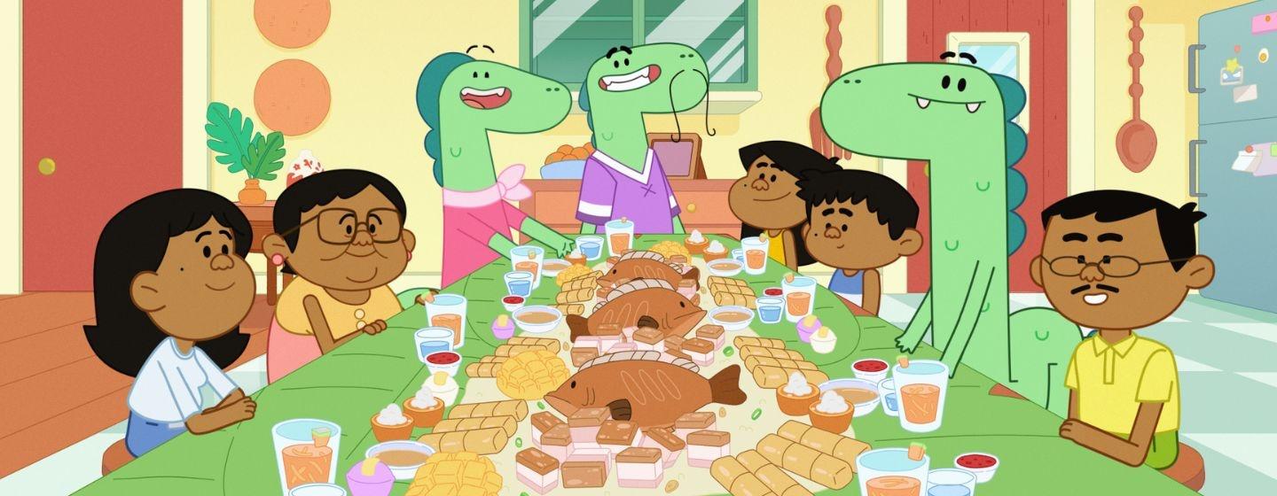 Jelly, Ben and Pogo sit around a dinner table full of food with their families.