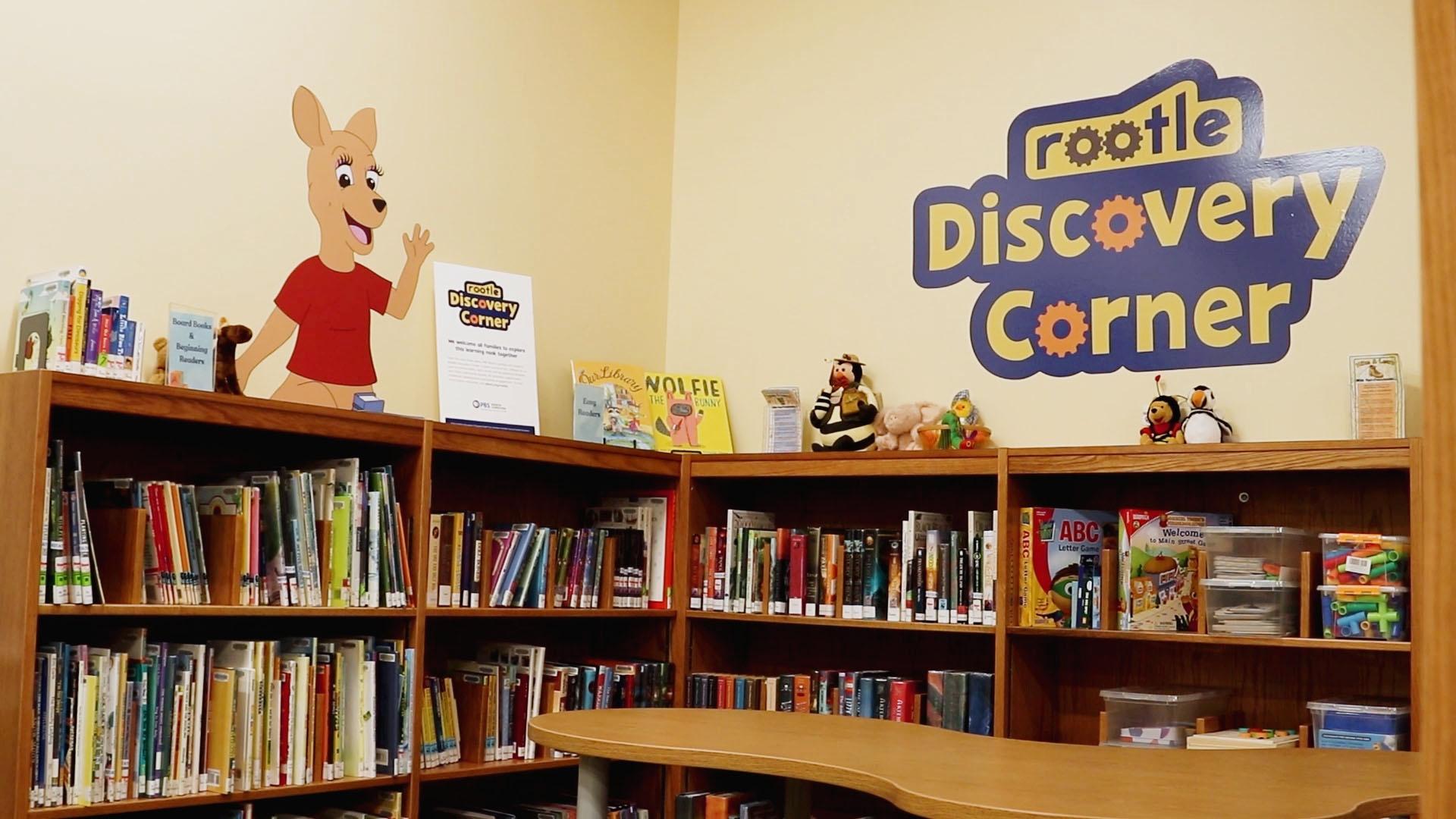 An image of a Rootle Discovery Corner in a library with half bookshelves full on children's books.