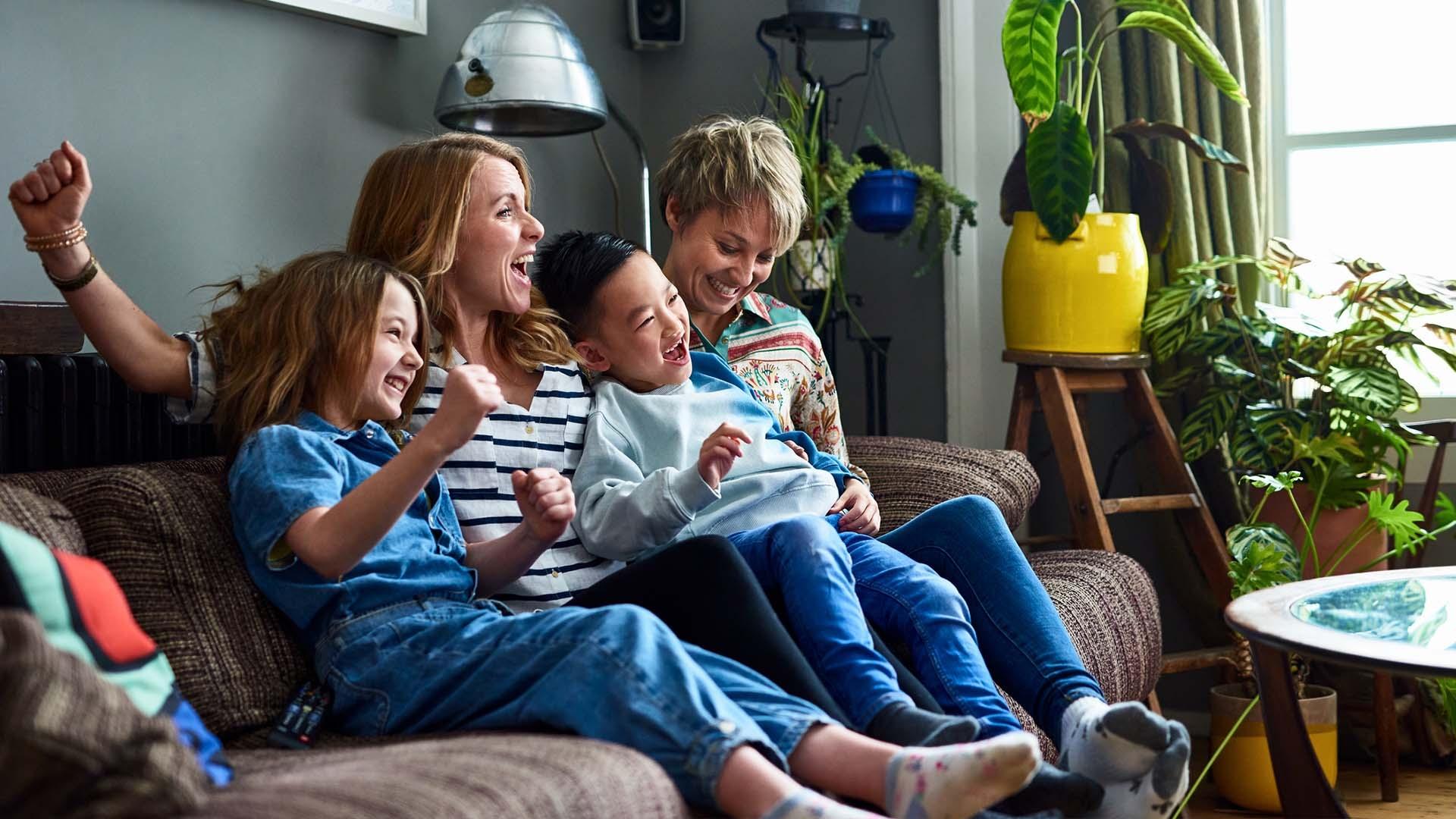 Mother with children smiling on the couch
