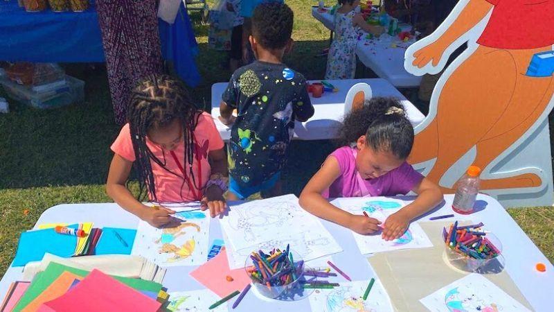 Children coloring at an outdoor event