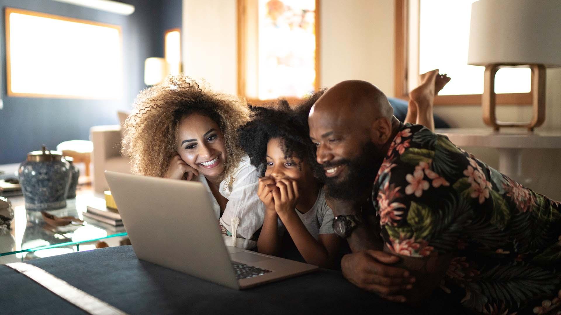 Family surfing through PBS Kids resources on a laptop