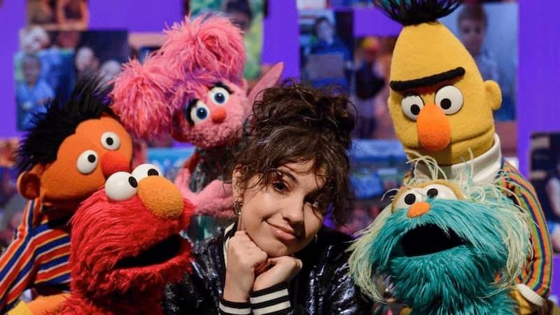 Sesame Street puppets with young host