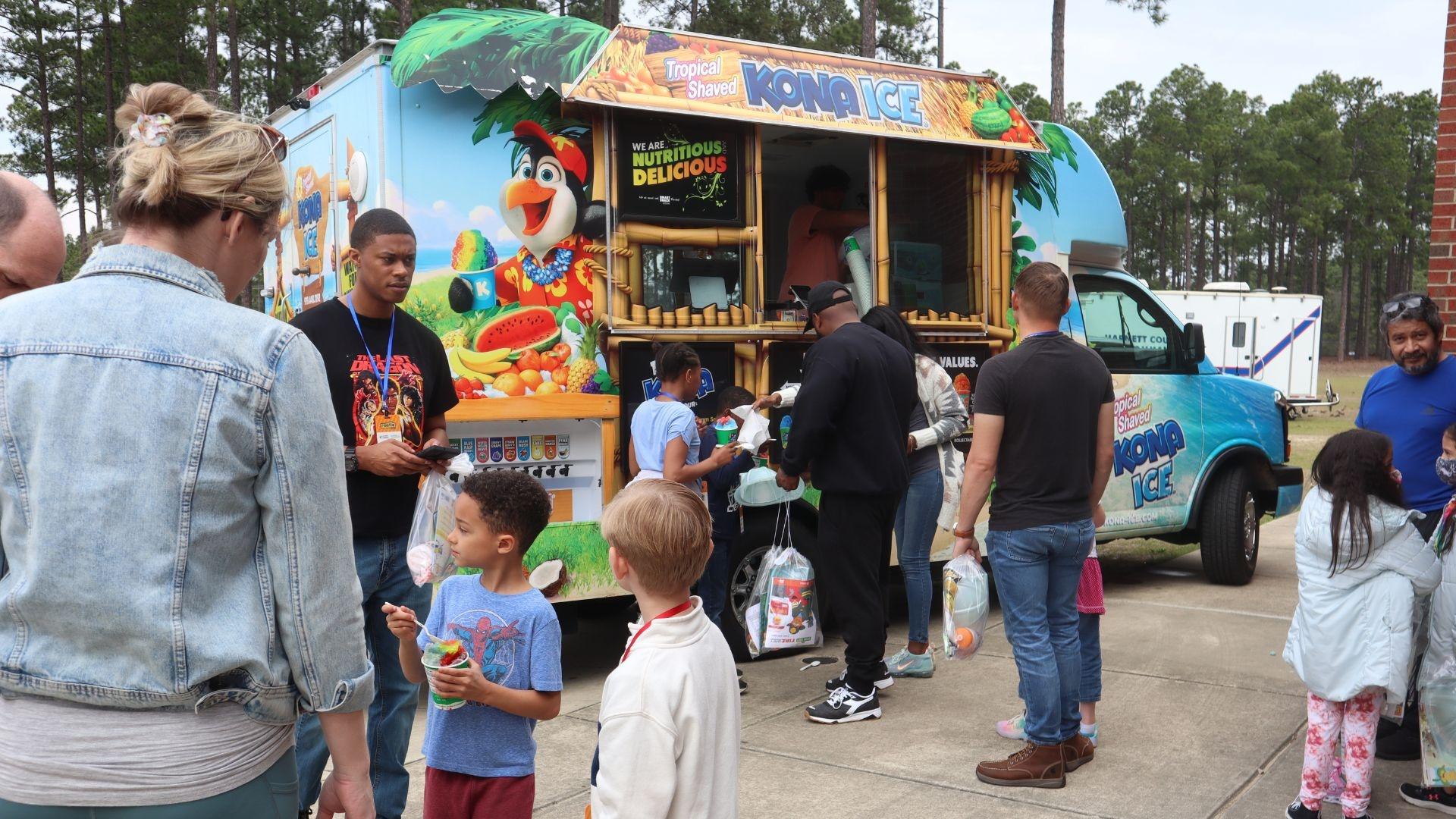 Families line up at Kona Ice food truck at a Rootle Roadster Tour stop.