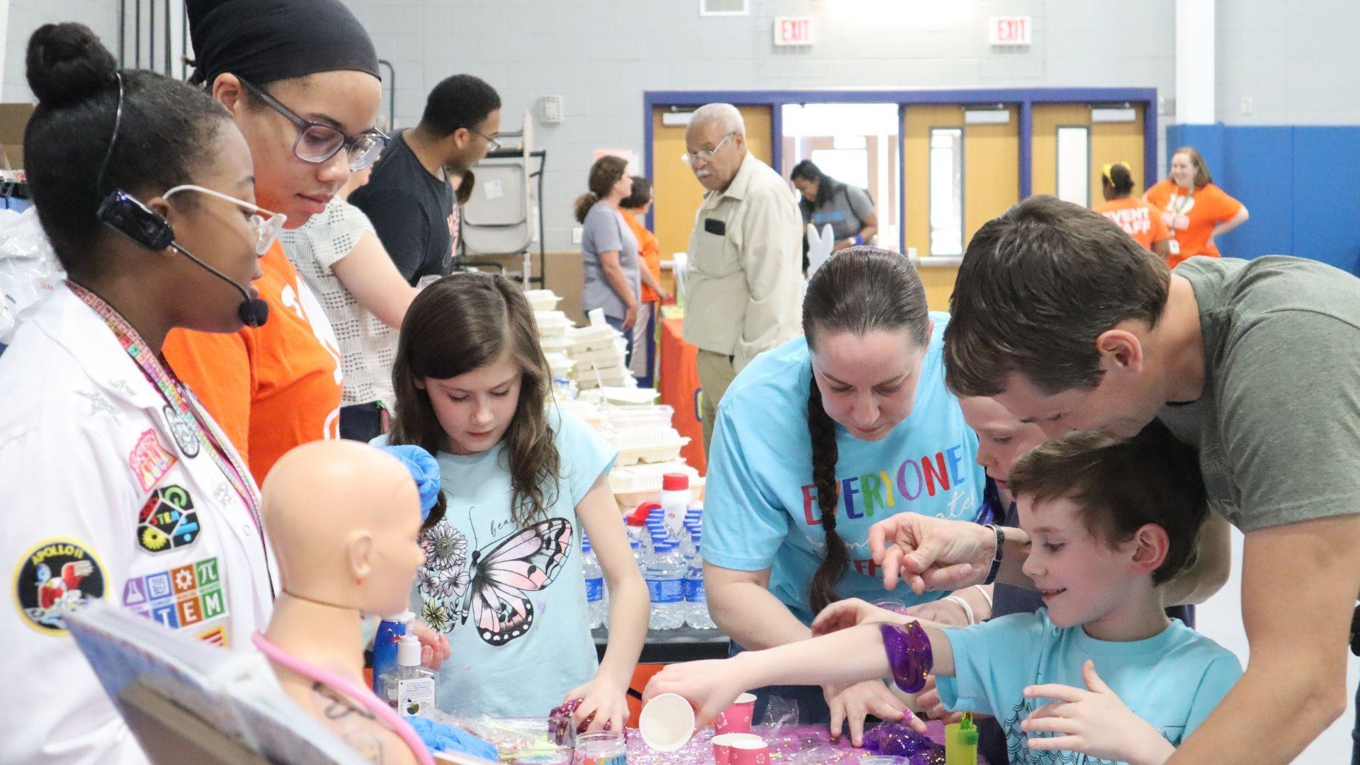 families learn science with Ava the STEM Princess at a Rootle Roadster Tour stop.