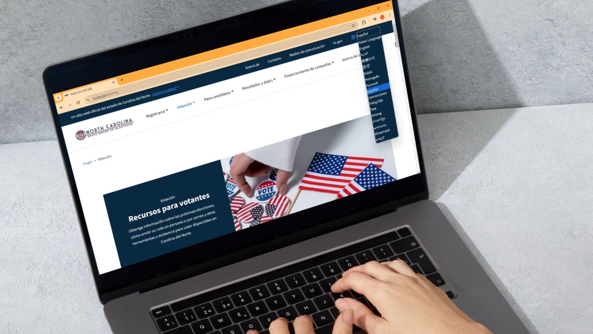 The State Board of Elections website is pulled up on a laptop, highlighting the language choice in the top right corner.