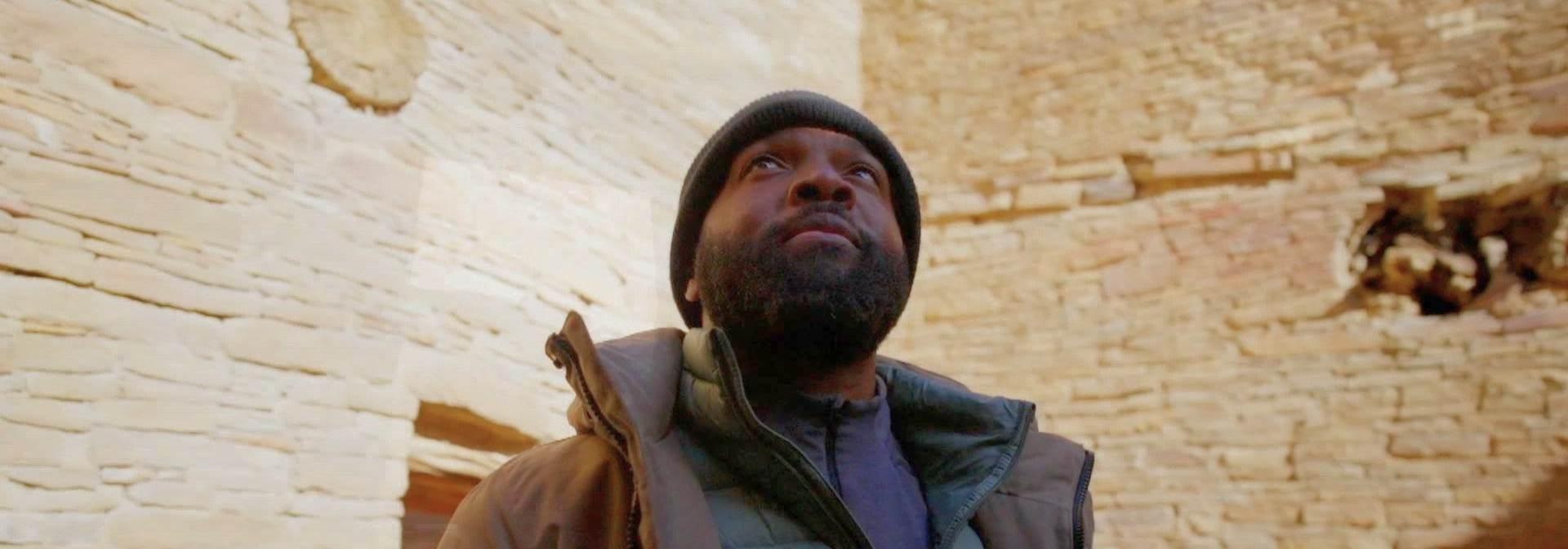 Baratunde Thurston wearing winter gear looking up.