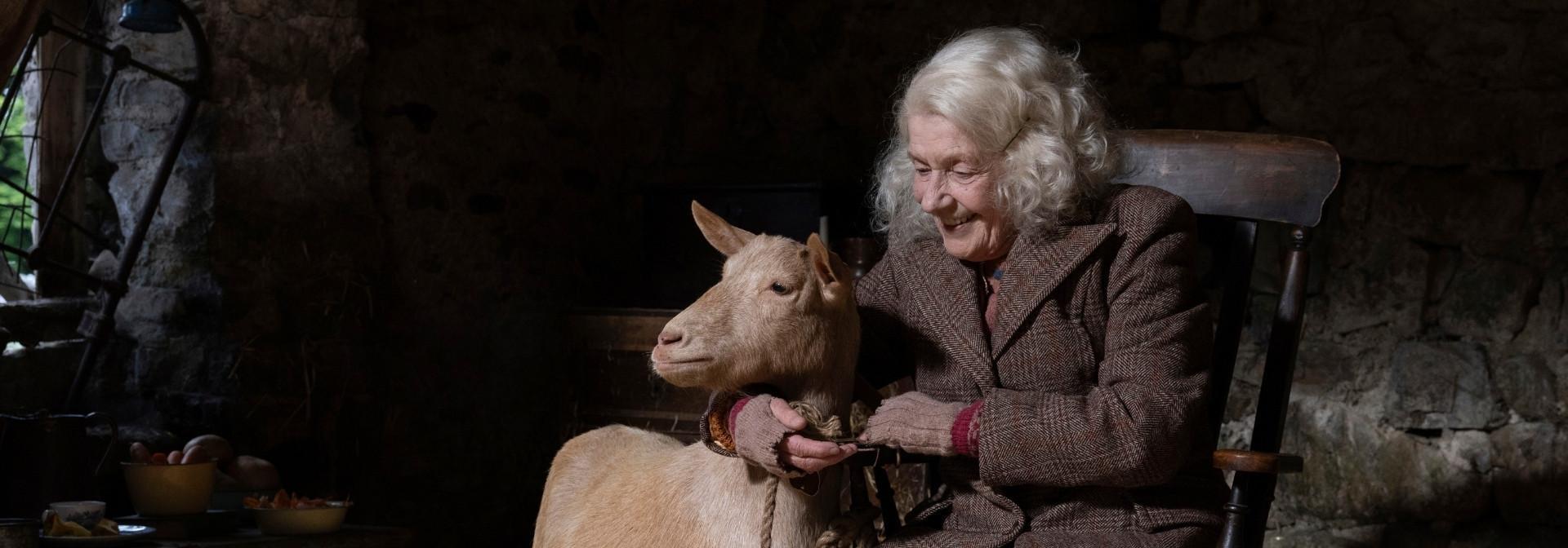 Mrs. Stokes (Susan Hilton) holding Hilda the goat.