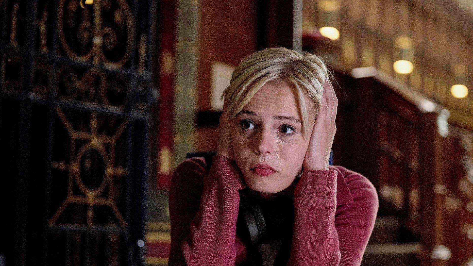 Ella Maisy Purvis as Patience Evans, a white woman with light blonde hair covering her ears with her hands.