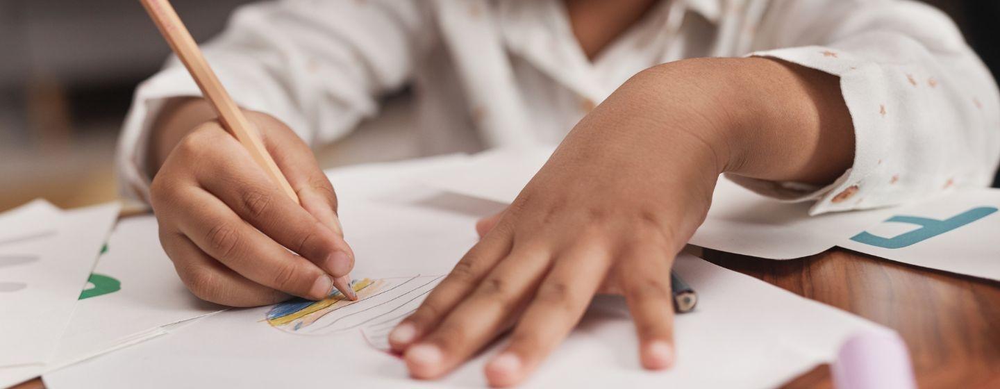 A close up of a child coloring.