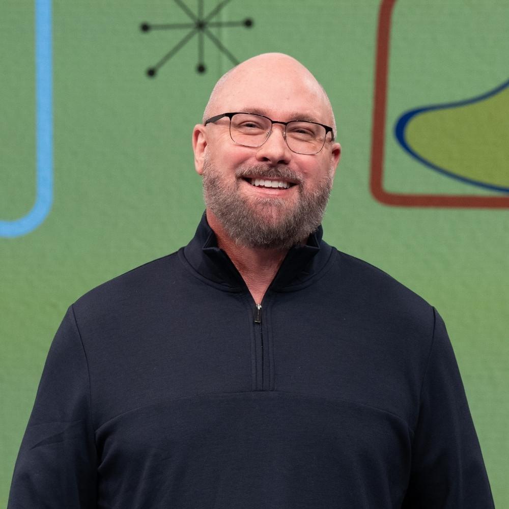 Jon Fowlkes, Deputy Environmental Health Section Chief. A white man with a grey beard, glasses and no hair wearing a dark blue quarter-zip jacket.