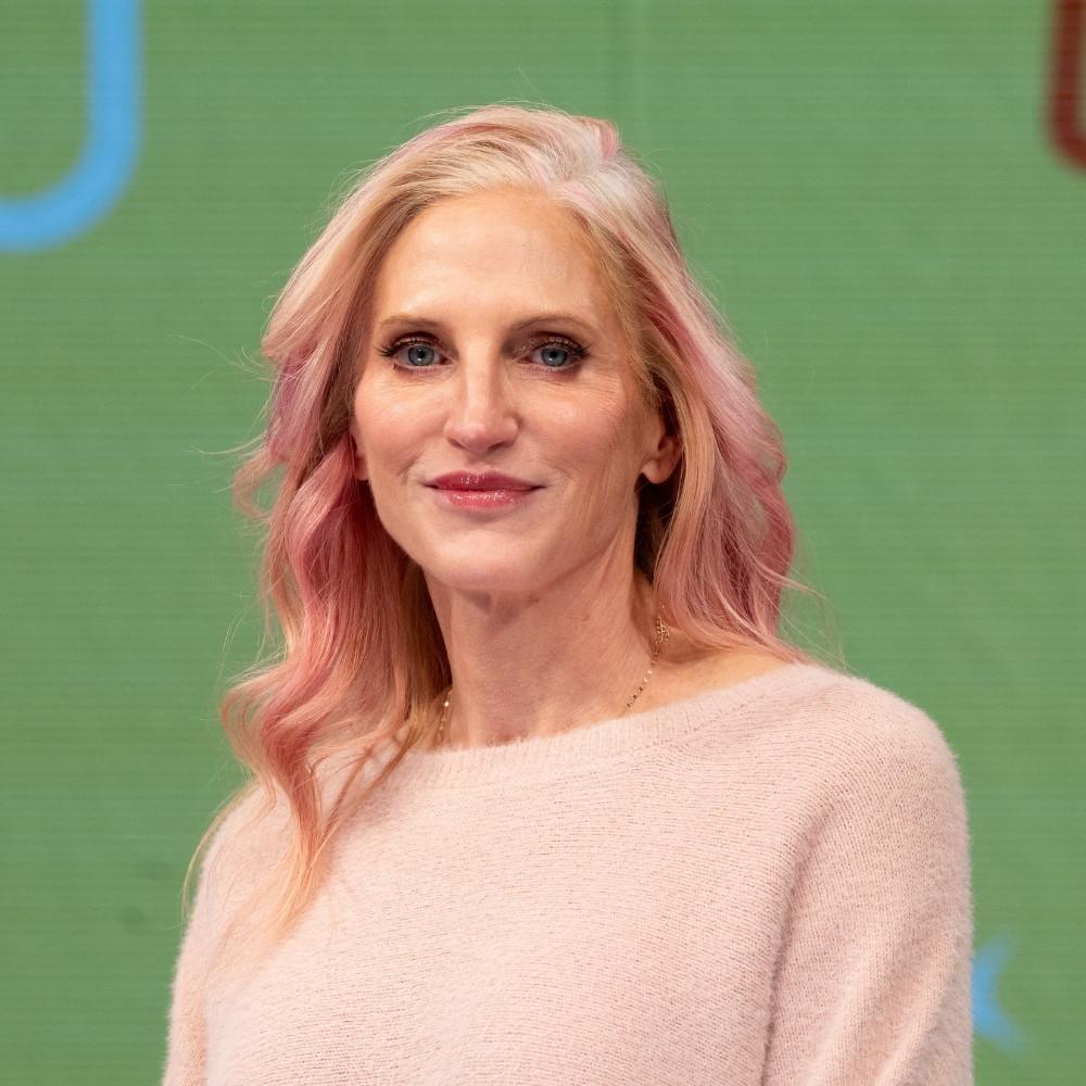 Dr. Kim McDonald, Section Chief, Chronic Disease and Injury, North Carolina Department of Health and Human Services Wake County. A white woman with pink hair and wearing a light pink sweater.