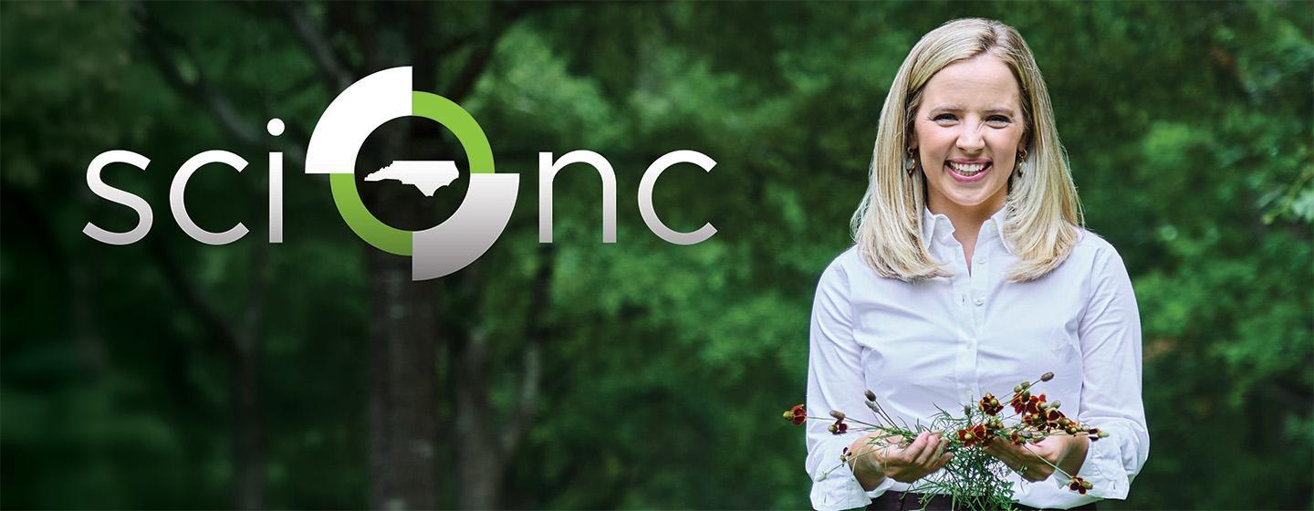 Sci NC host Laura Smith holding flowers with green trees in the background