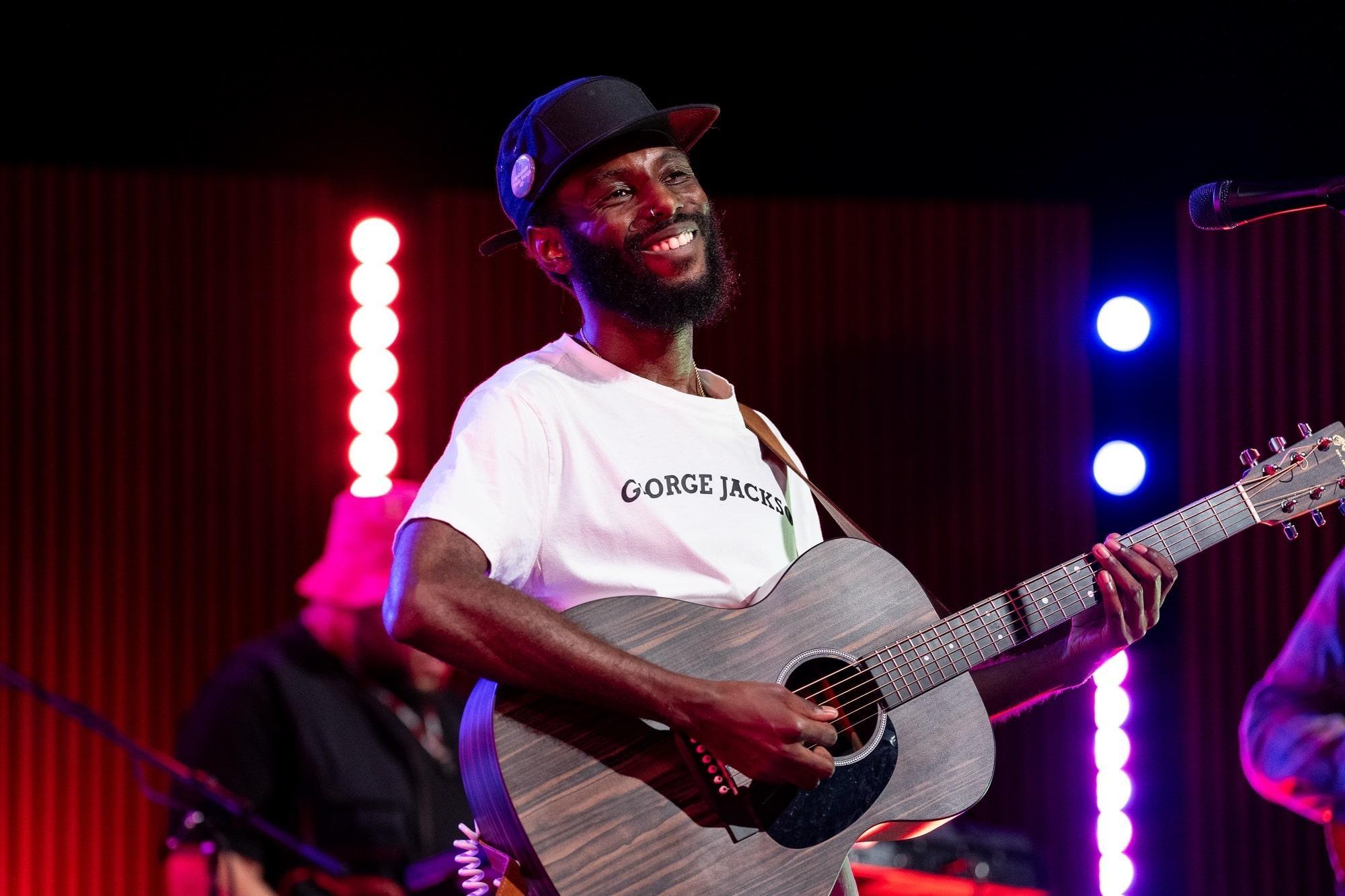 Sonny Miles plays acoustic guitar.