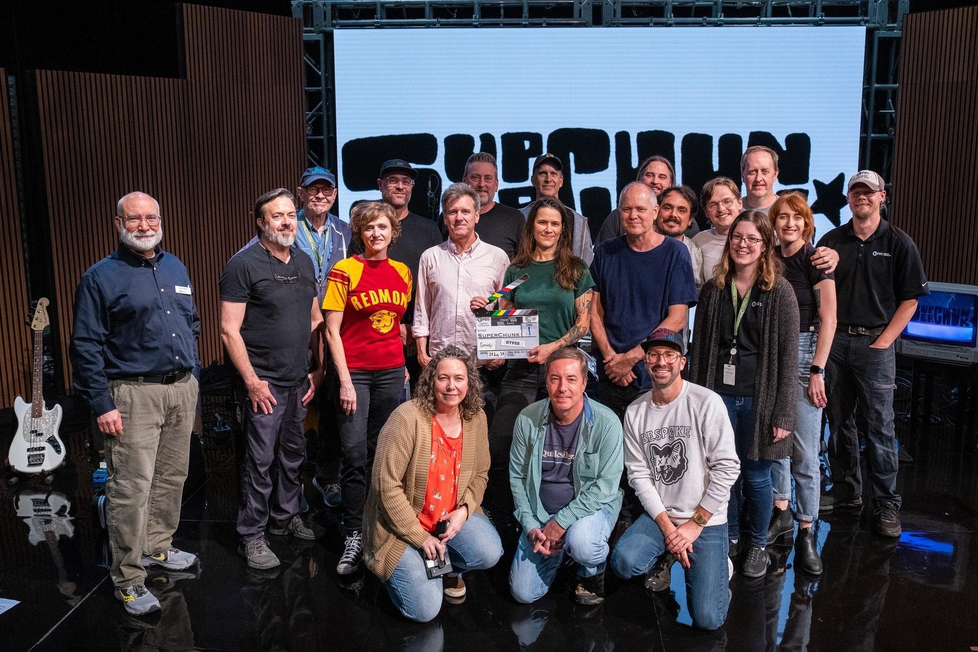 Superchunk and the Shaped by Sound production team posing together on set.