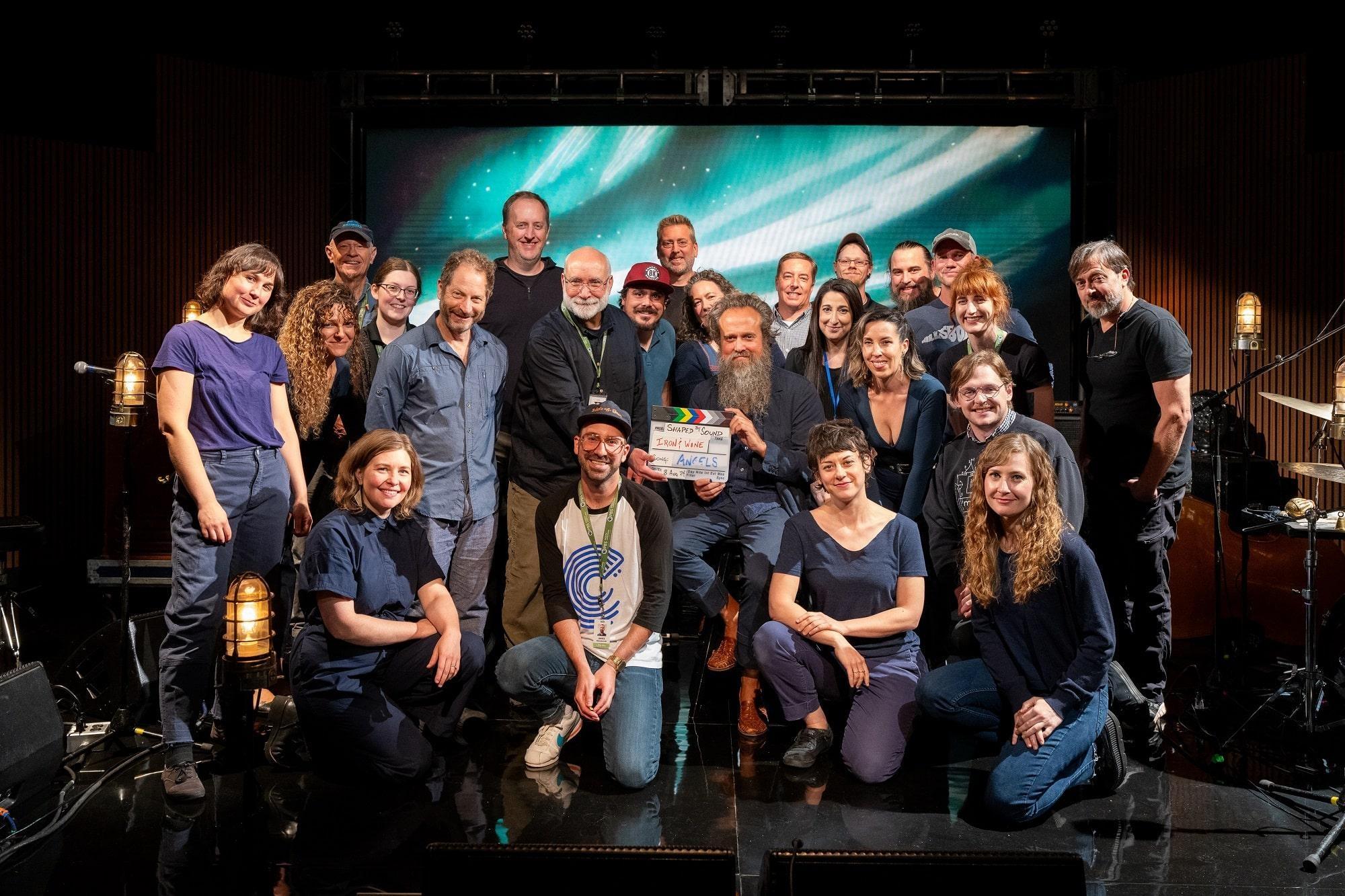 Iron & Wine, Manual Cinema and the Shaped by Sound production team posing together on set.