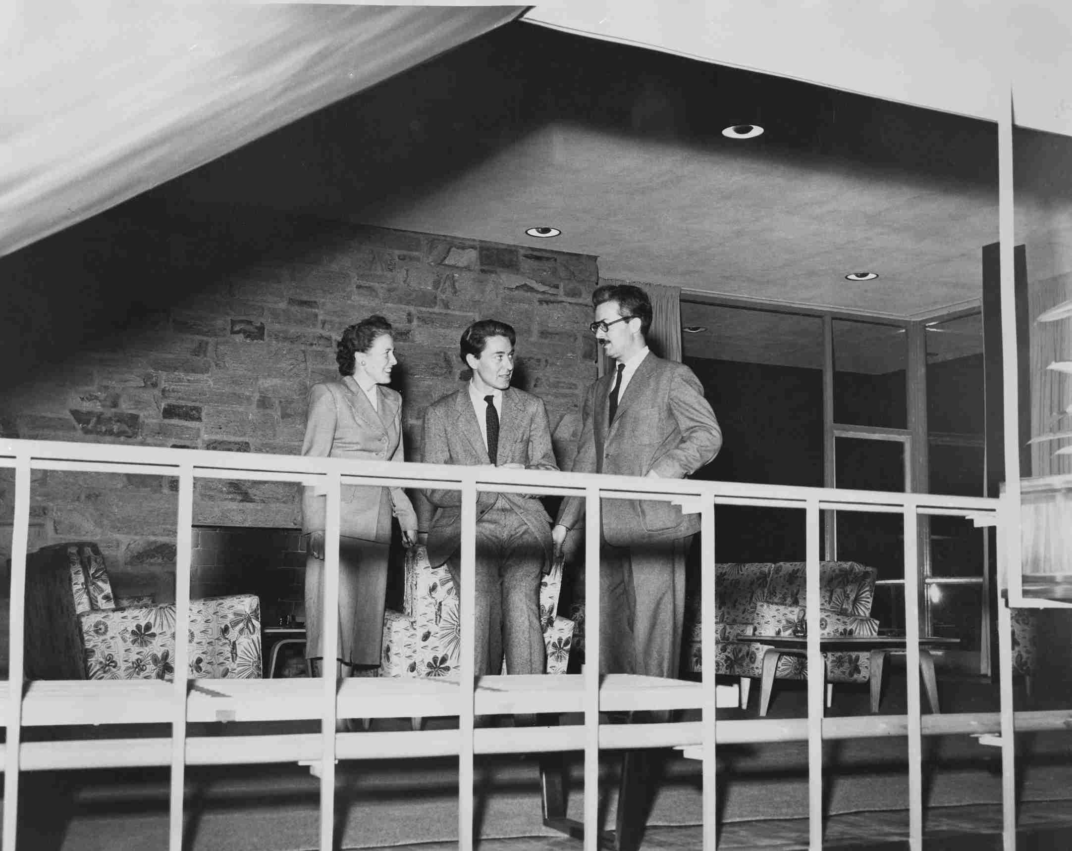 Dorton Arena architect Matthew Nowicki (center) and wife Stanislawa Nowicki in conversation with Henry Kamphoefner, Dean of the NC State School of Design, on the balcony at Carolina Country Club. 1949. Photographer: Bill Garrett.