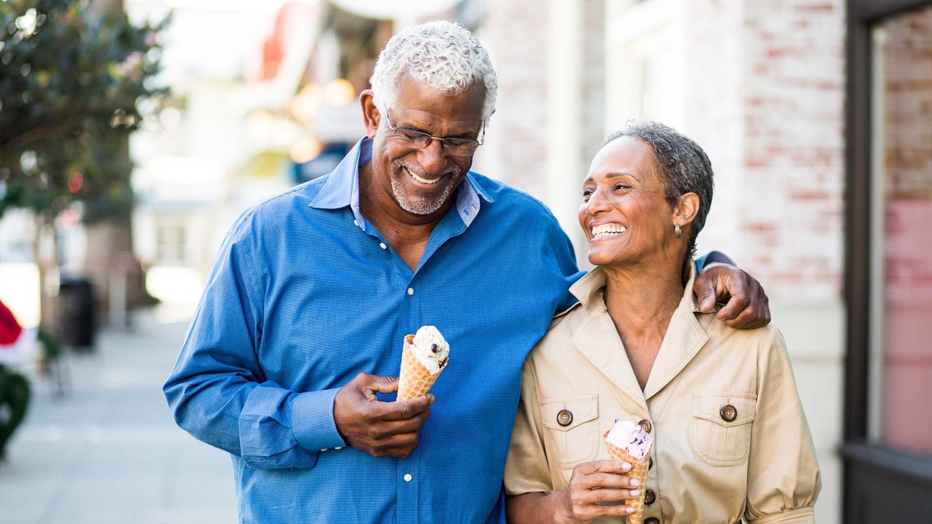 smiling couple while eating ice cream 
