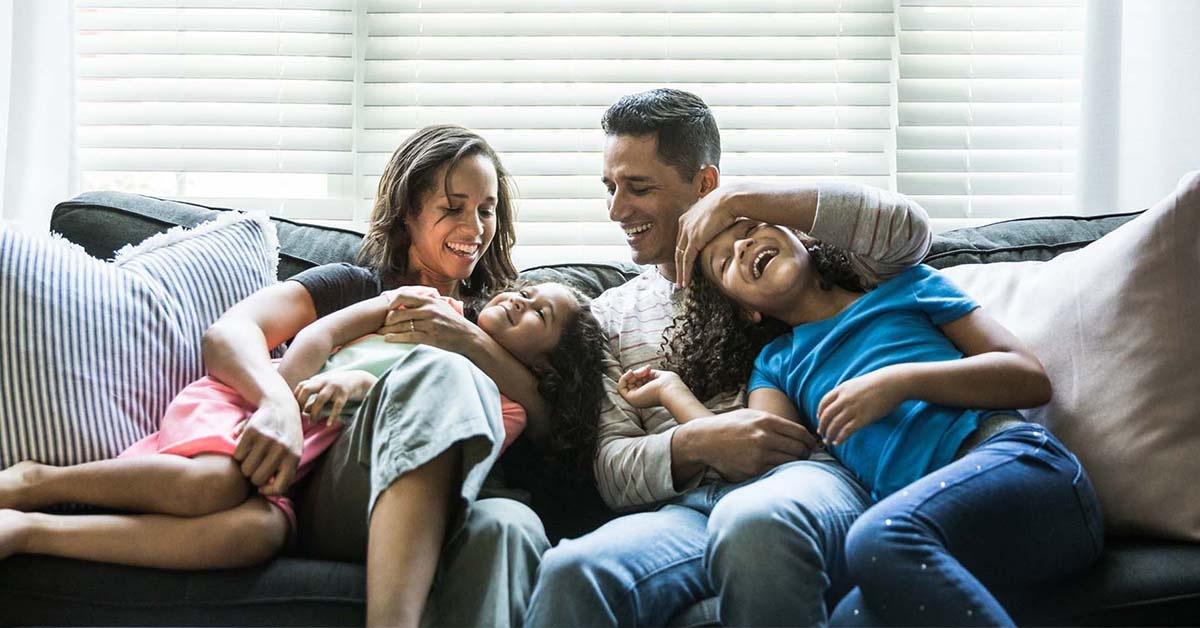 Smiling parents with children on the couch