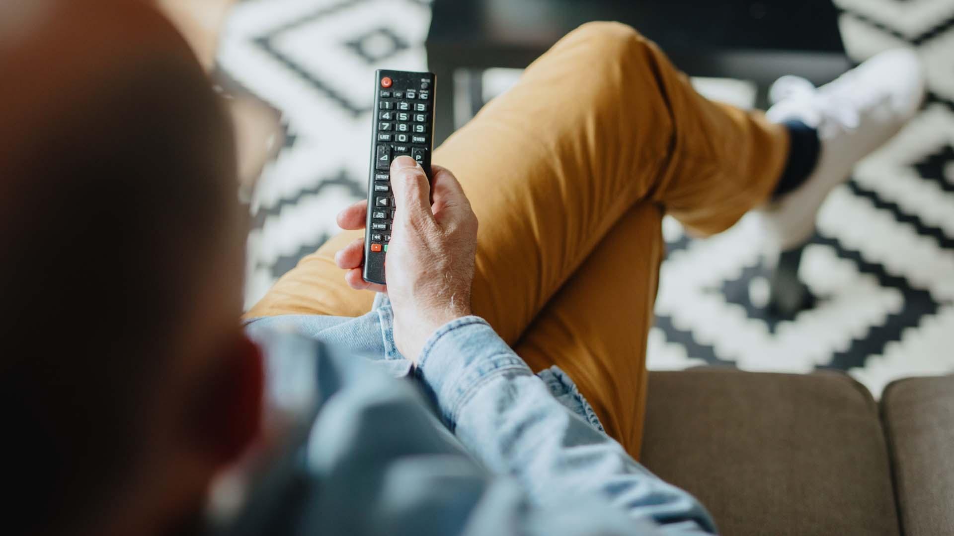Man holding a tv remote