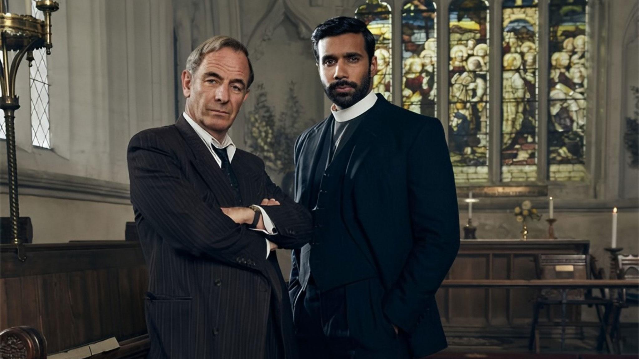 A picture of Grantchester actors in the middle of a church