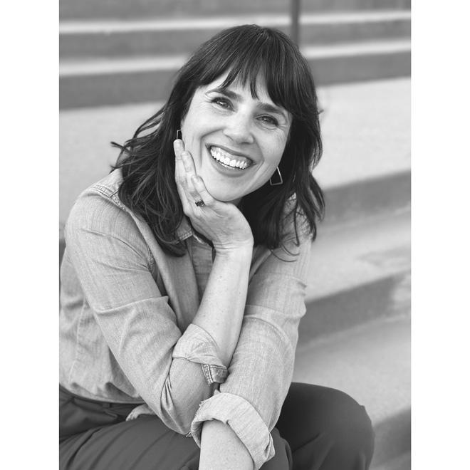 Black and white photo of Laura Durham smiling.