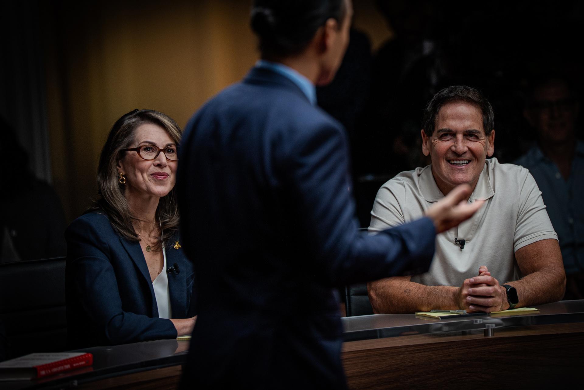 Deidre M. Henderson and Mark Cuban listening to Moderator Aaron Tang on the set of BREAKING the DEADLOCK.