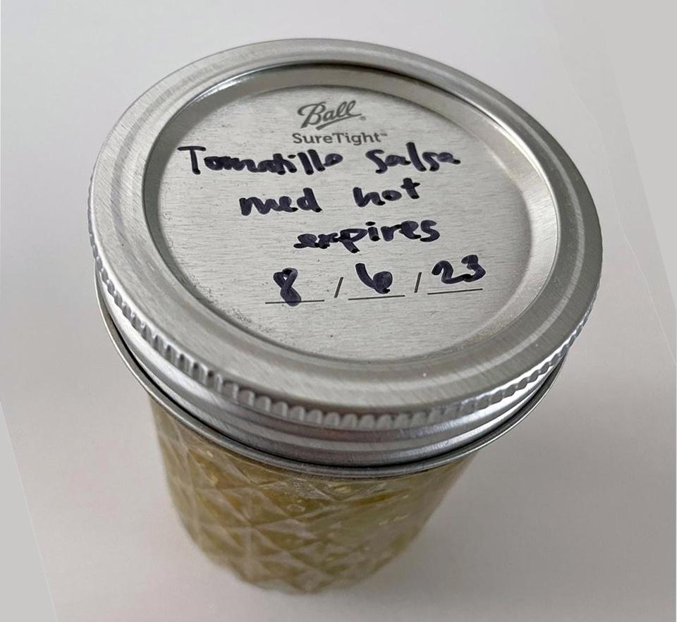 Photo: Cindy's canned Tomatillo Salsa, labeled with expiration date.