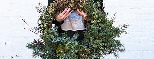 Person holding wreath