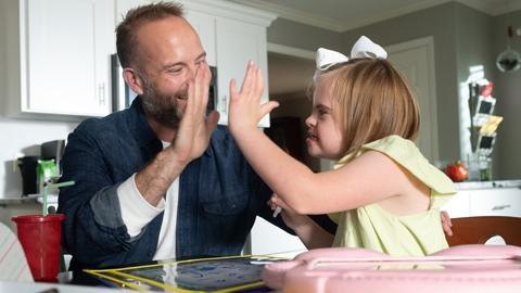 Father high fiving his daughter