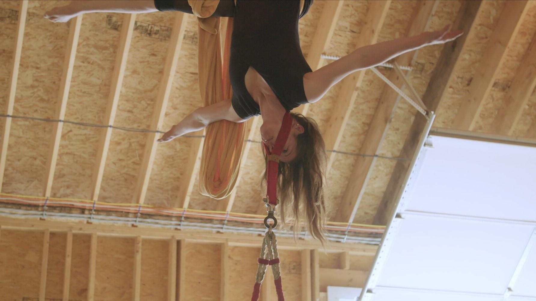 photo of a woman upside down in trapeze