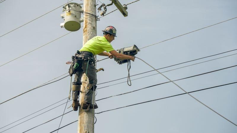 photo of a man on a utility pole