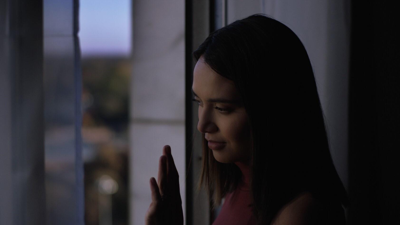 photo of an attractive woman looking out a window